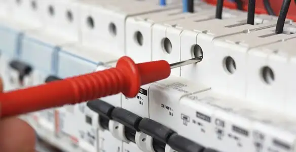 Electrical contractor testing circuit breakers during electrical repair in Wadesville, IN