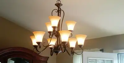 Classic ceiling chandelier installation with warm lighting in Evansville, IN