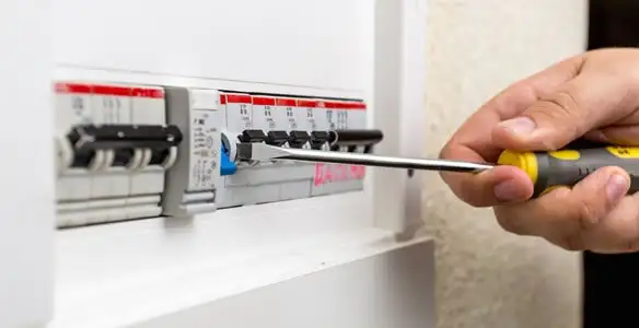 electrical panel upgrade service showing technician adjusting circuit breakers during system upgrade in Evansville, IN