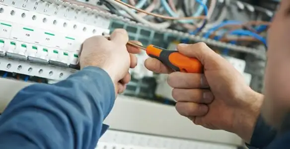 electrical service showing licensed electrician performing electrical panel maintenance and adjustments in Evansville, IN