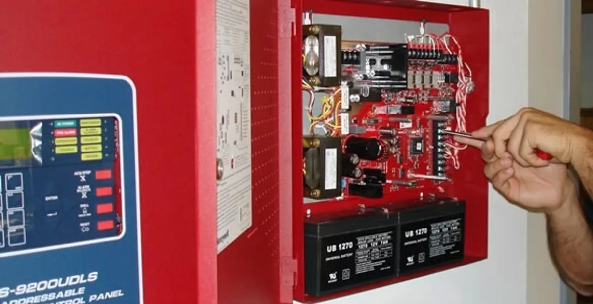 fire alarm installation service showing technician configuring fire alarm control panel in Evansville, IN