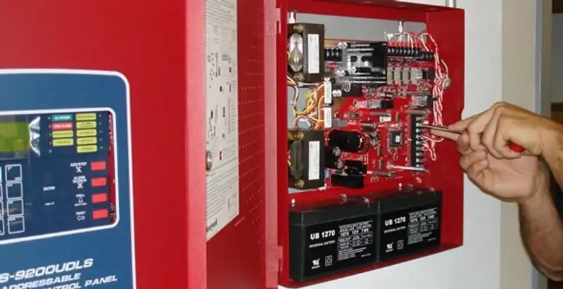 fire alarm installation service showing technician configuring fire alarm control panel in Evansville, IN