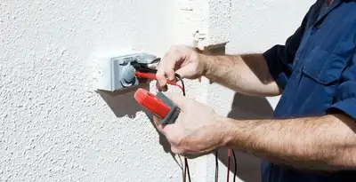 Electrician performing home electrical outlet and wiring inspection in Evansville, IN