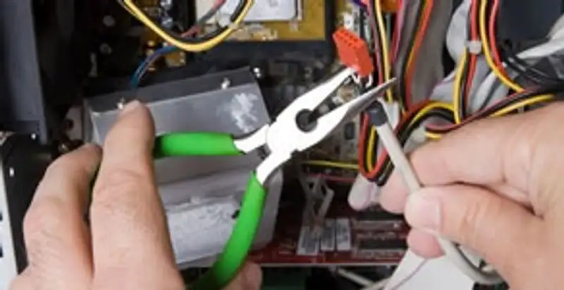 Licensed electrical contractor performing electrical repair with tools in Boonville, IN