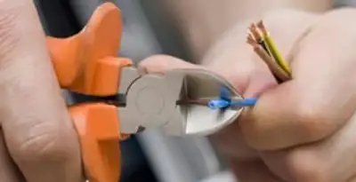 professional electrical services showing precise wire cutting by licensed electricians in Evansville, IN