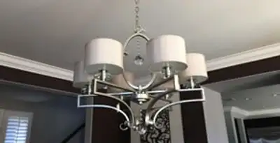Modern chandelier installation with multiple light fixtures in Evansville, IN