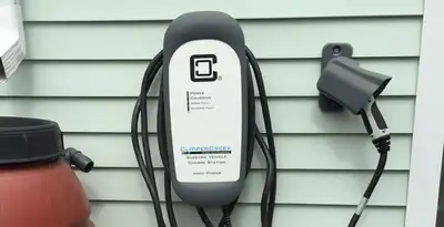 Outdoor electric vehicle charger installation on residential wall in Evansville, IN