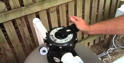 pool pumps service showing professional adjustment of pool pump control system in Evansville, IN